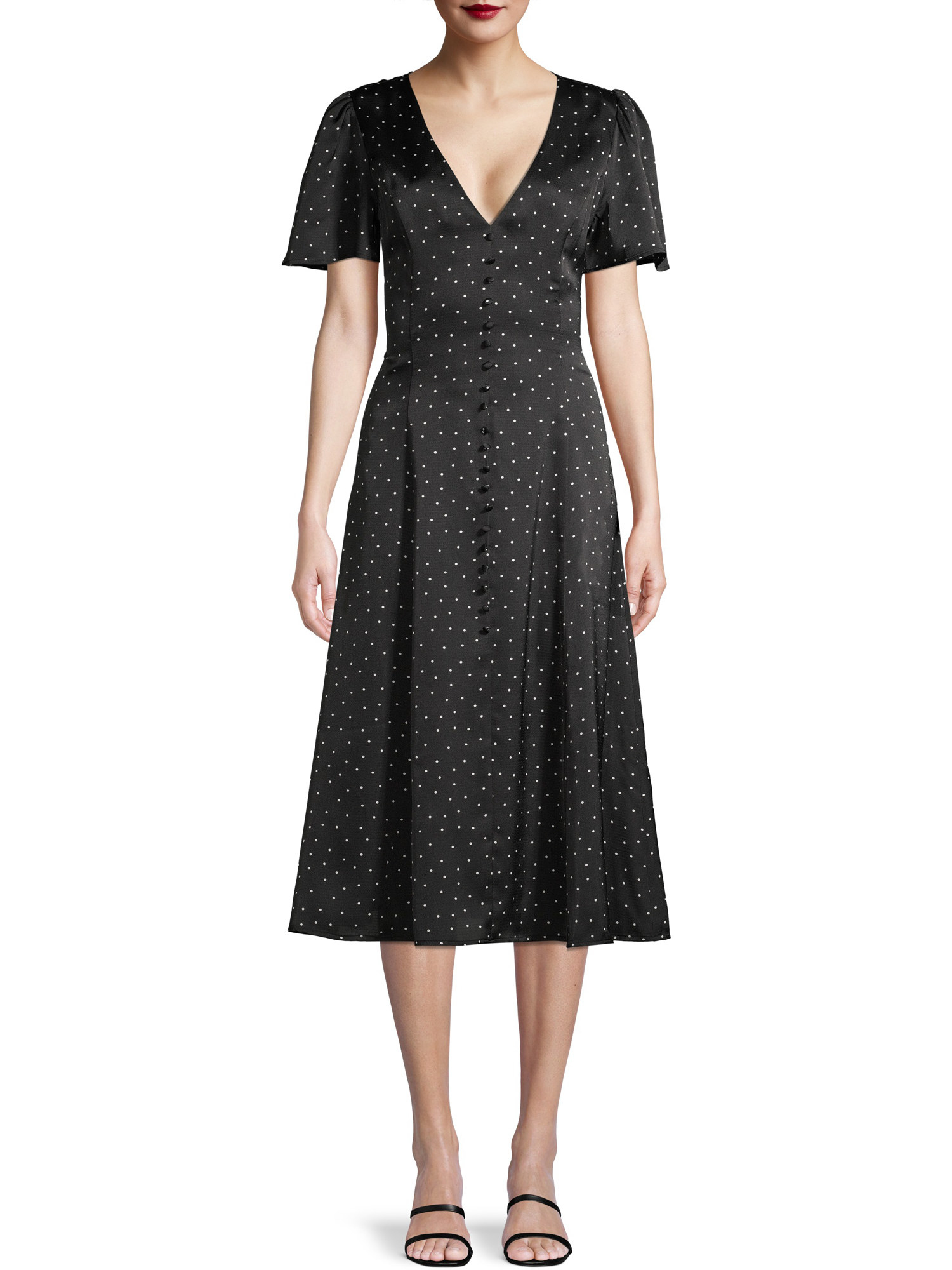 Model wearing black knee-length polka-dot dress 