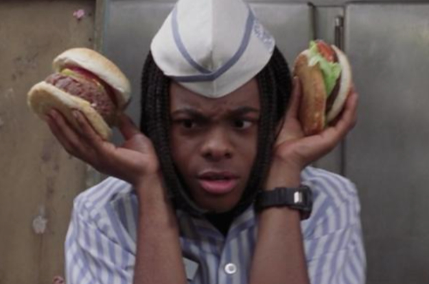Kel from the movie Good Burger holding two burgers up to his ears