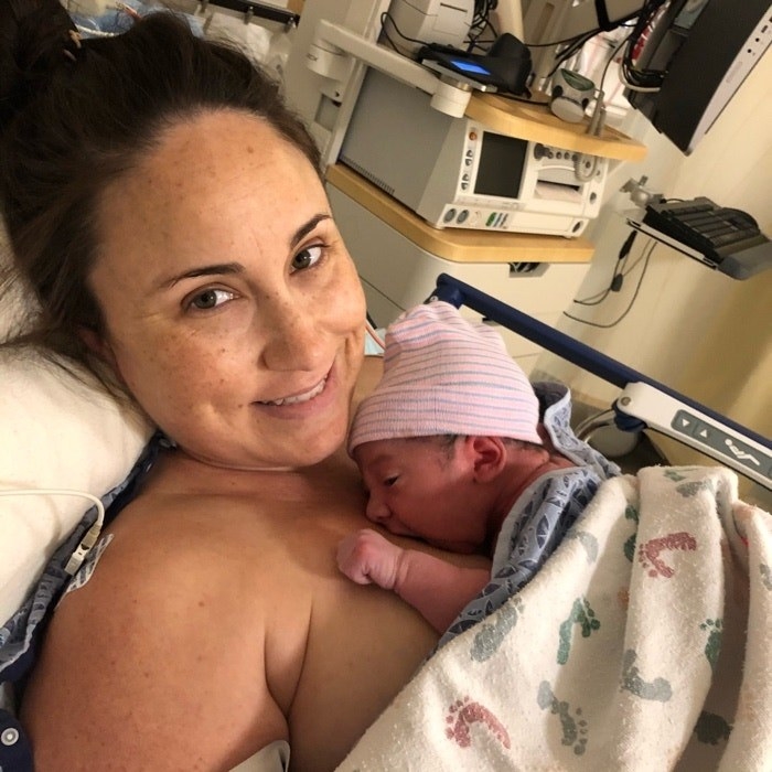 Photo of mom with baby in hospital bed.