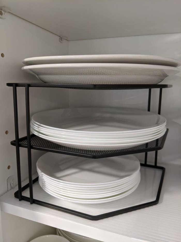 reviewer&#x27;s plates stacked on their shelf and the two upper tiers of the organizer 