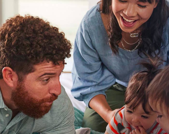 Two parents and two children playing together