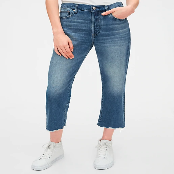 The jeans have a raw hem and hit just below mid-calf