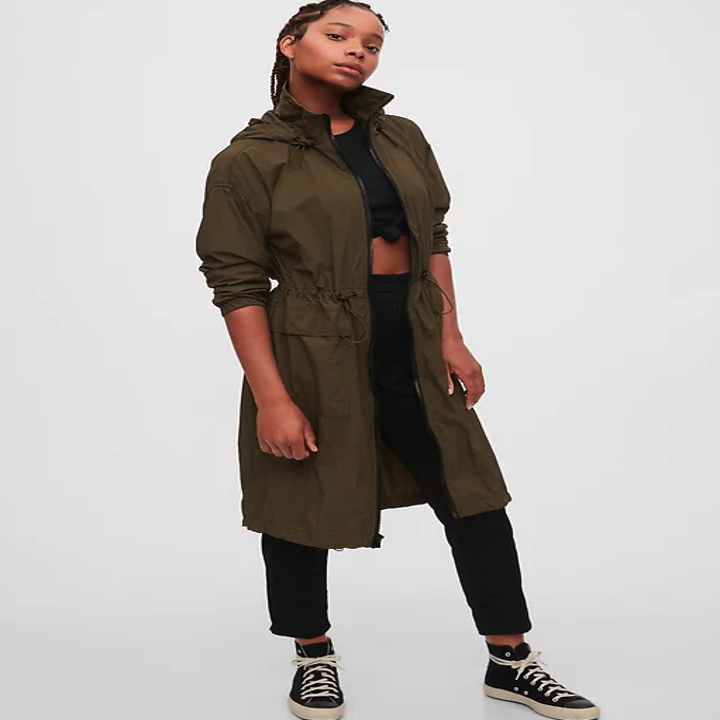 A model wears the jacket in olive green, the hem hits her knees