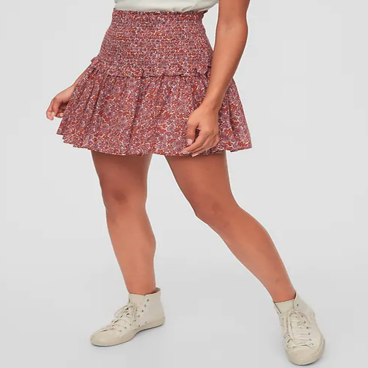 A model wears the tiered miniskirt in orange floral