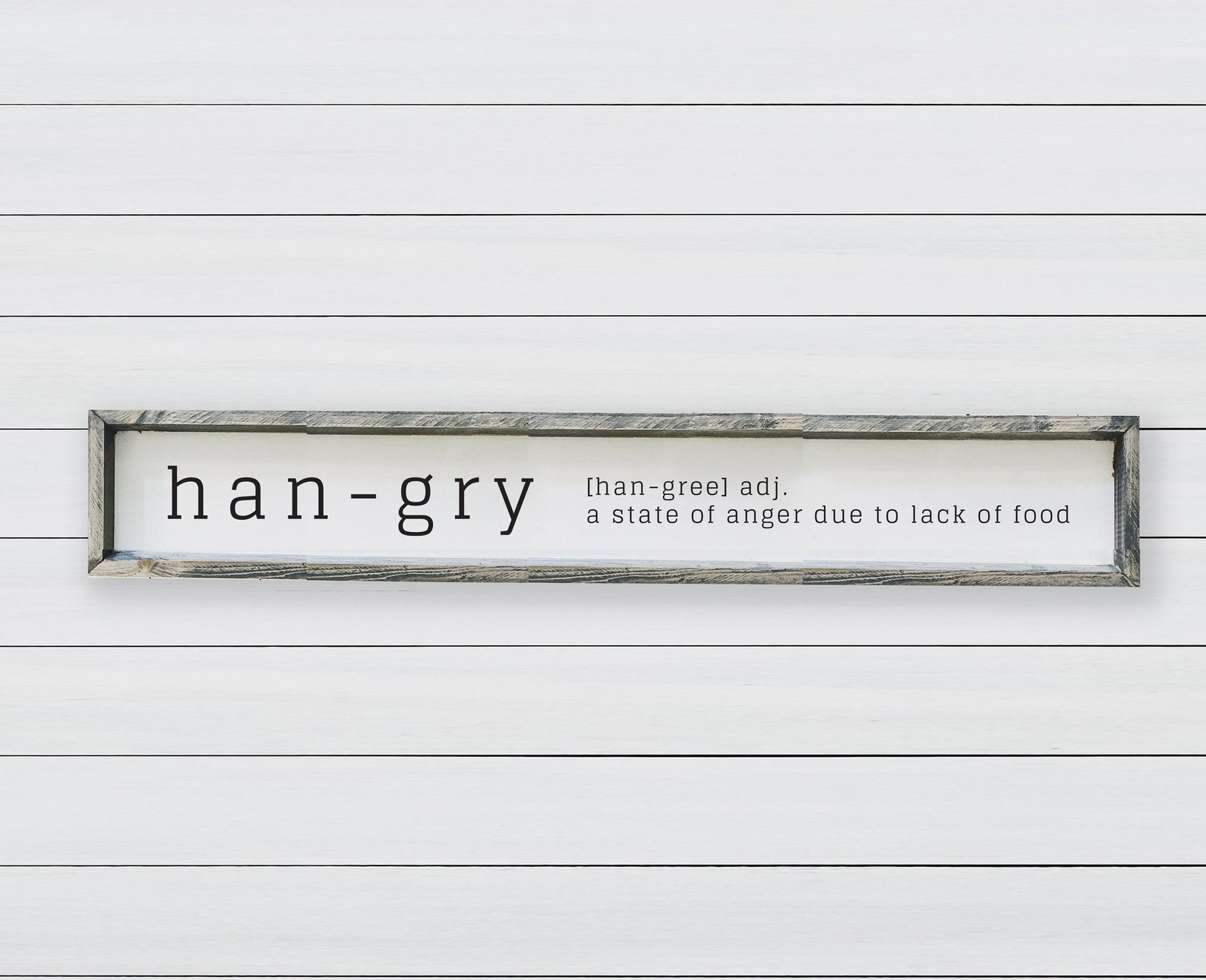 The rectangular wooden frame sign that says &quot;han-gry, a state of anger due to lack of food&quot;