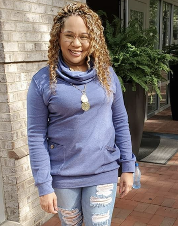 reviewer wearing the cowl neck sweater in blue 