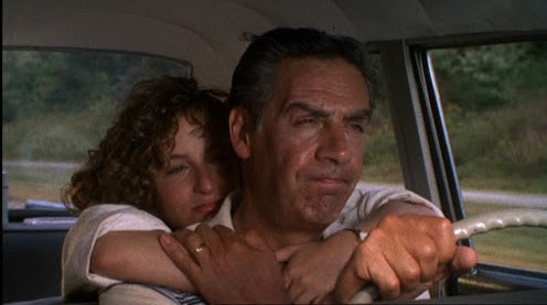 Baby hugging her dad from behind as her dad, Jake, as he drives the car in &quot;Dirty Dancing.&quot; 