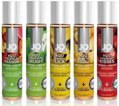 System Jo lube bottles in Tropical Passion, Green Apple Delight, Banana Lick, Juicy Pineapple, and Strawberry Kisses