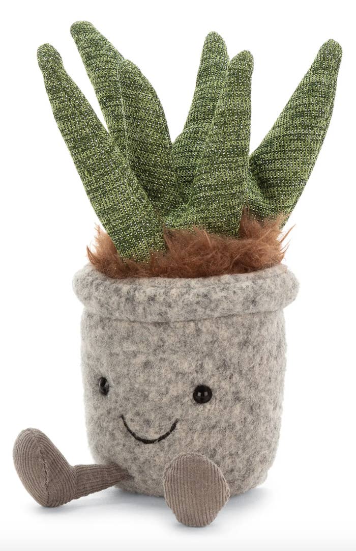 Stuffed toy Aloe plant with a smiling face and tiny legs.