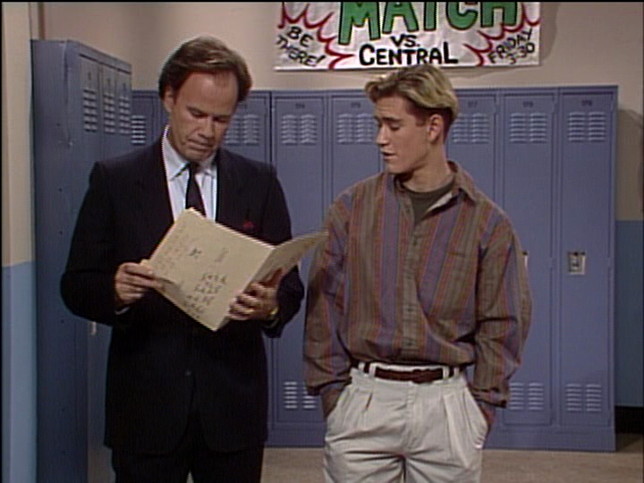 Mr. Belding checking a file next to Zack Morris in the hallway. 