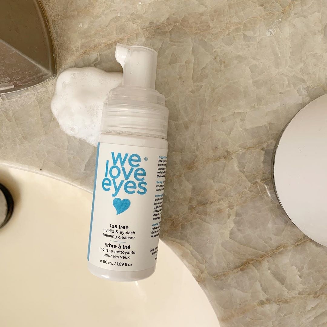 A flatlay of the eyelid cleaner on a marble bathroom counter