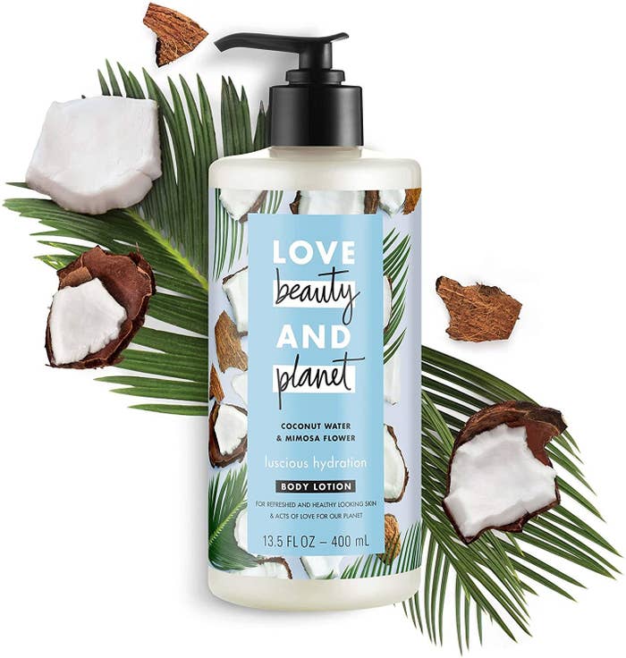 A body lotion  on a background with chunks of coconut and palm leaves