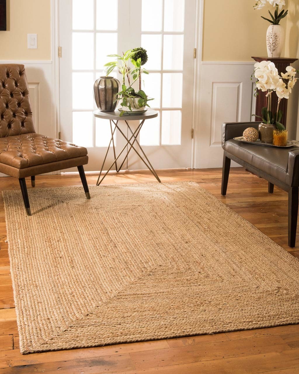 A rectangular jute rug placed on a hardwood floor. 