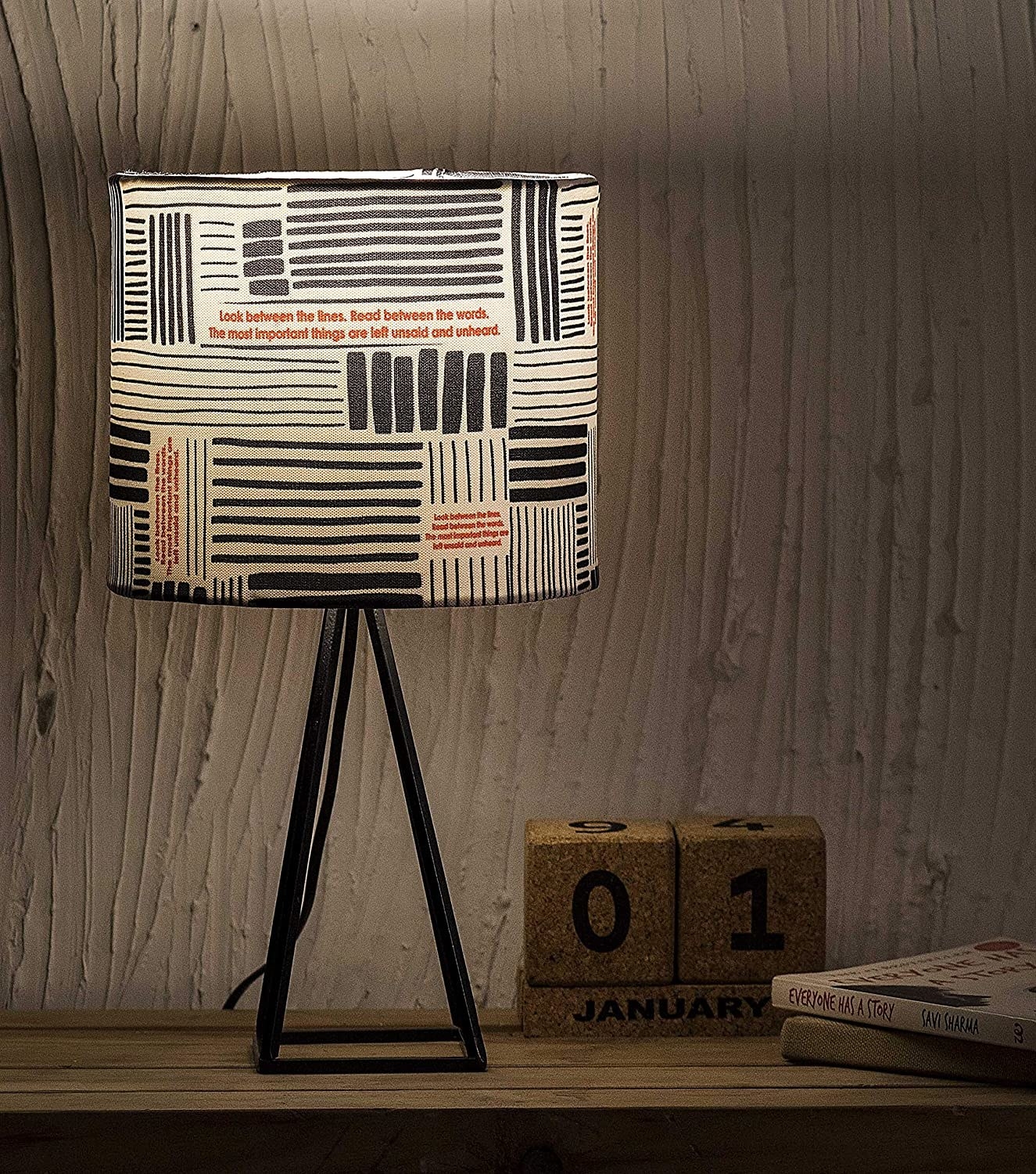 A white lamp with black stripes and red text on it.