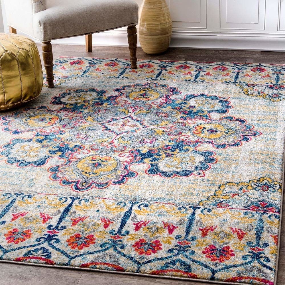 A multi-coloured carpet in shades of cream, blue, red, and yellow.