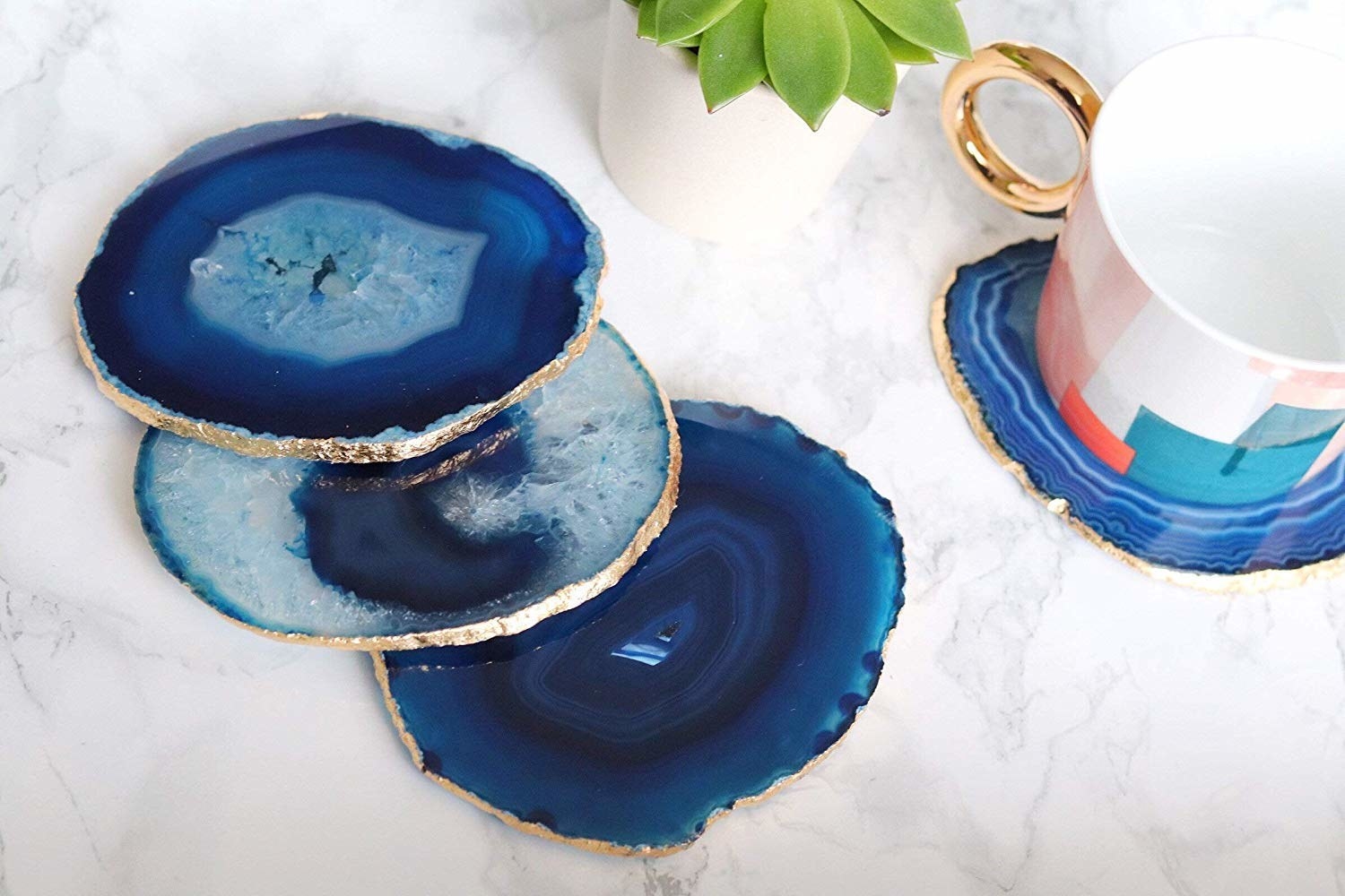 Blue-gold agate coasters and a mug kept on one of them.