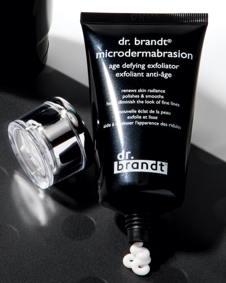 dr brant microdermabrasion product in black tube with some white product spilling out on to a countertop