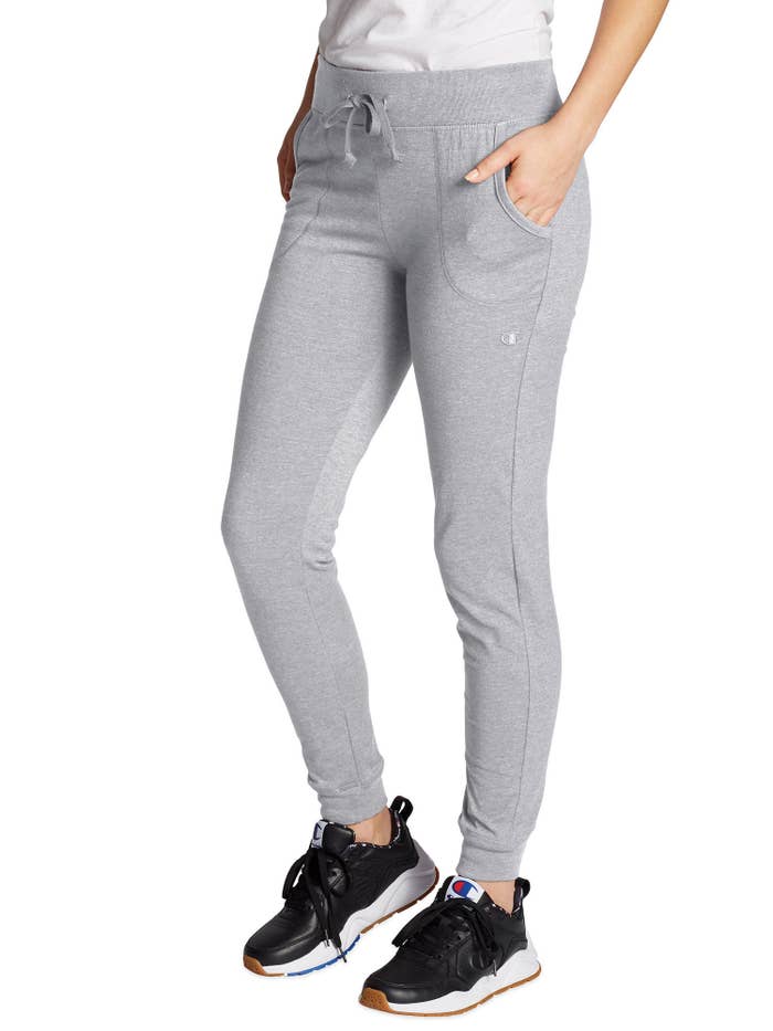 Model wearing gray joggers and black tennis shoes