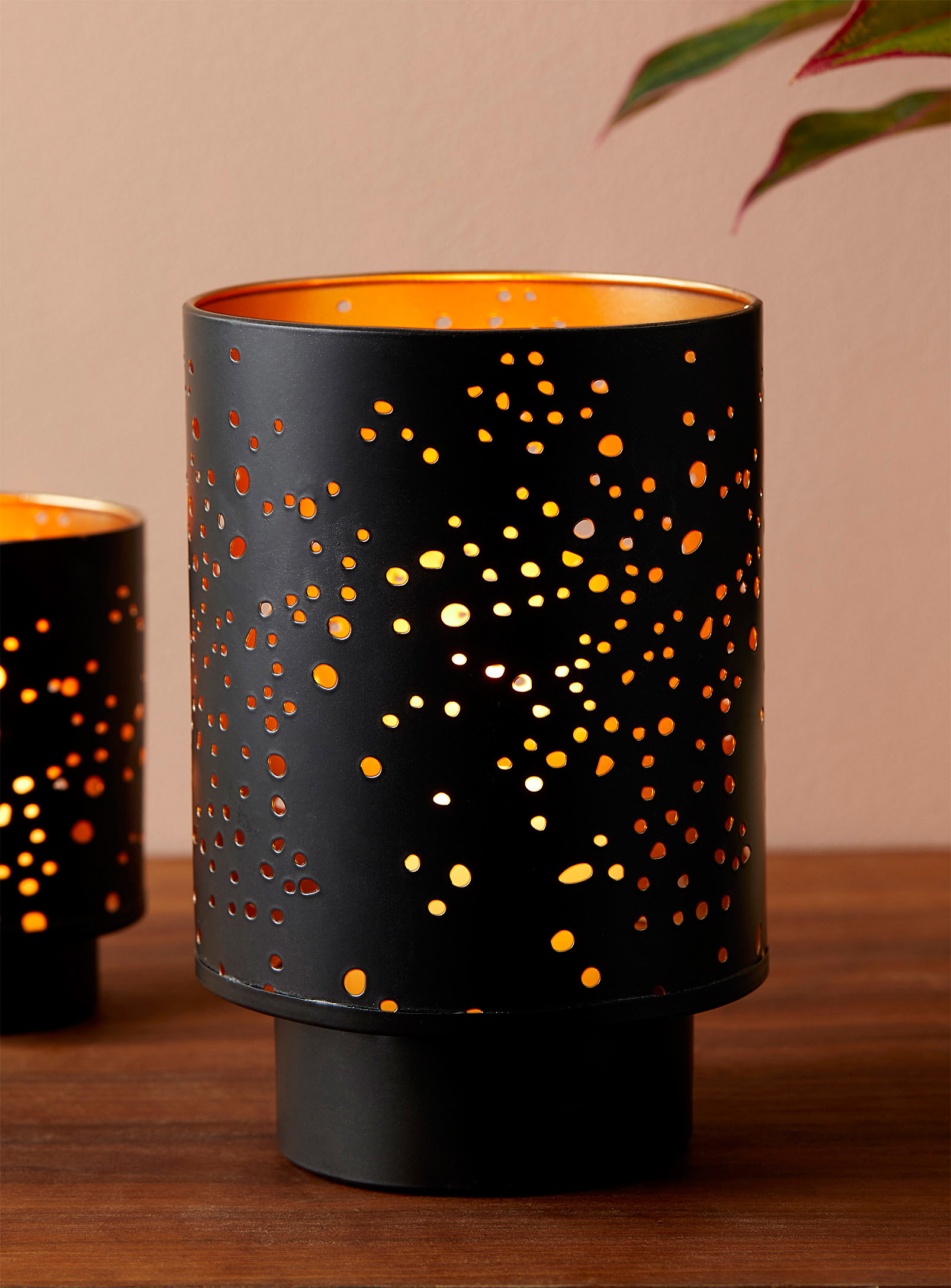 A small candle holder with holes on the sides
