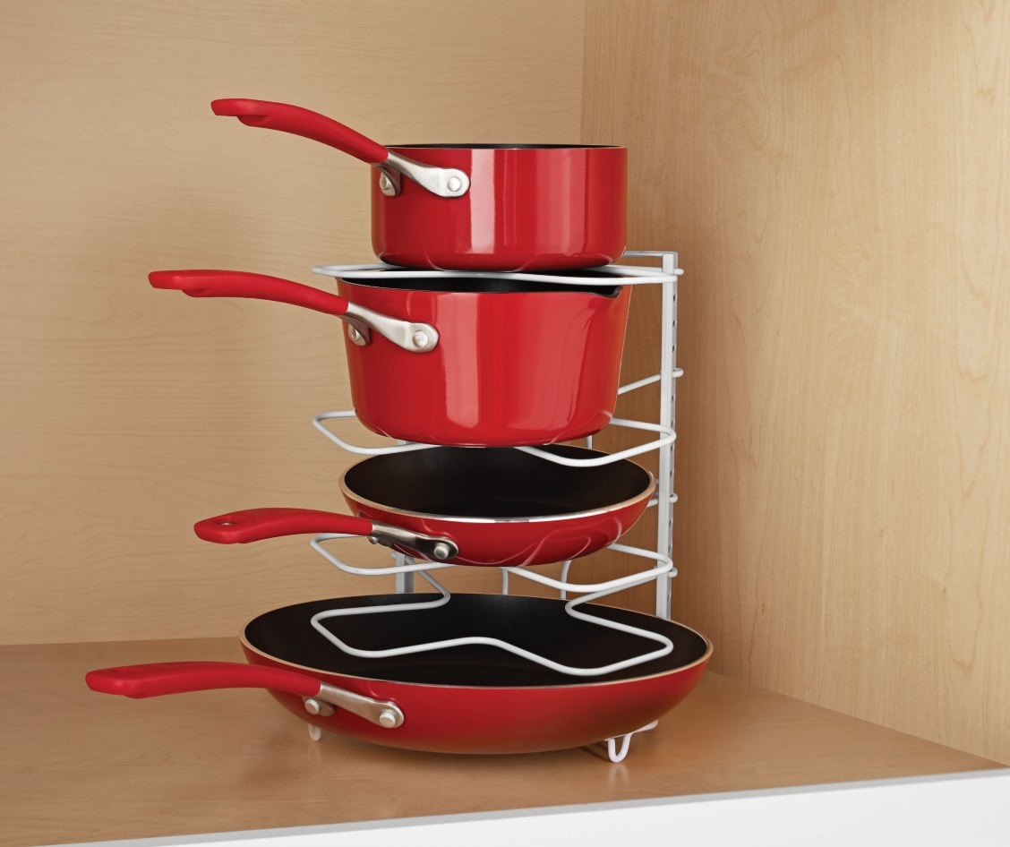 The organization rack being used to hold pots and pans