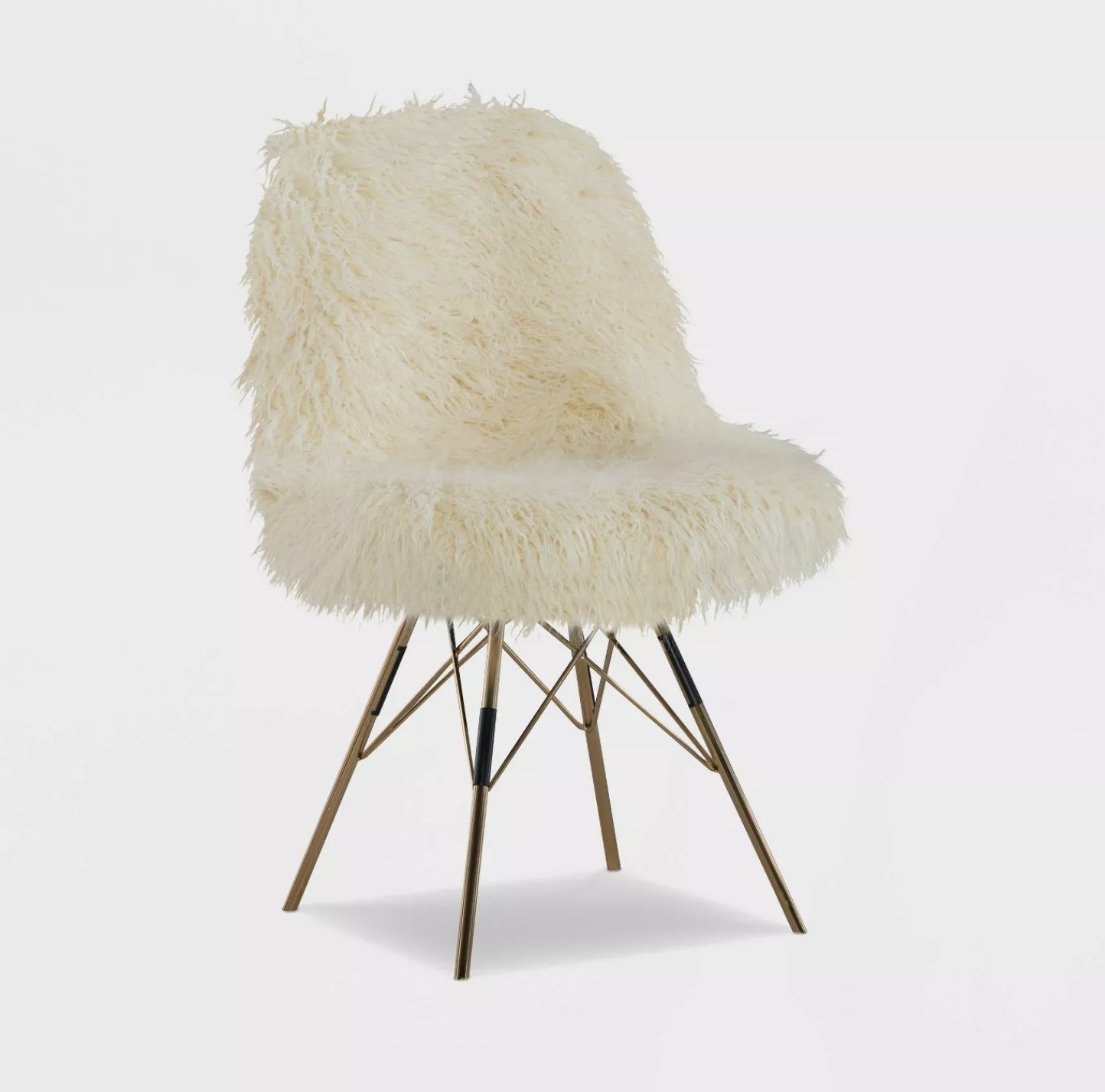 A cream faux fur chair with gold chrome legs