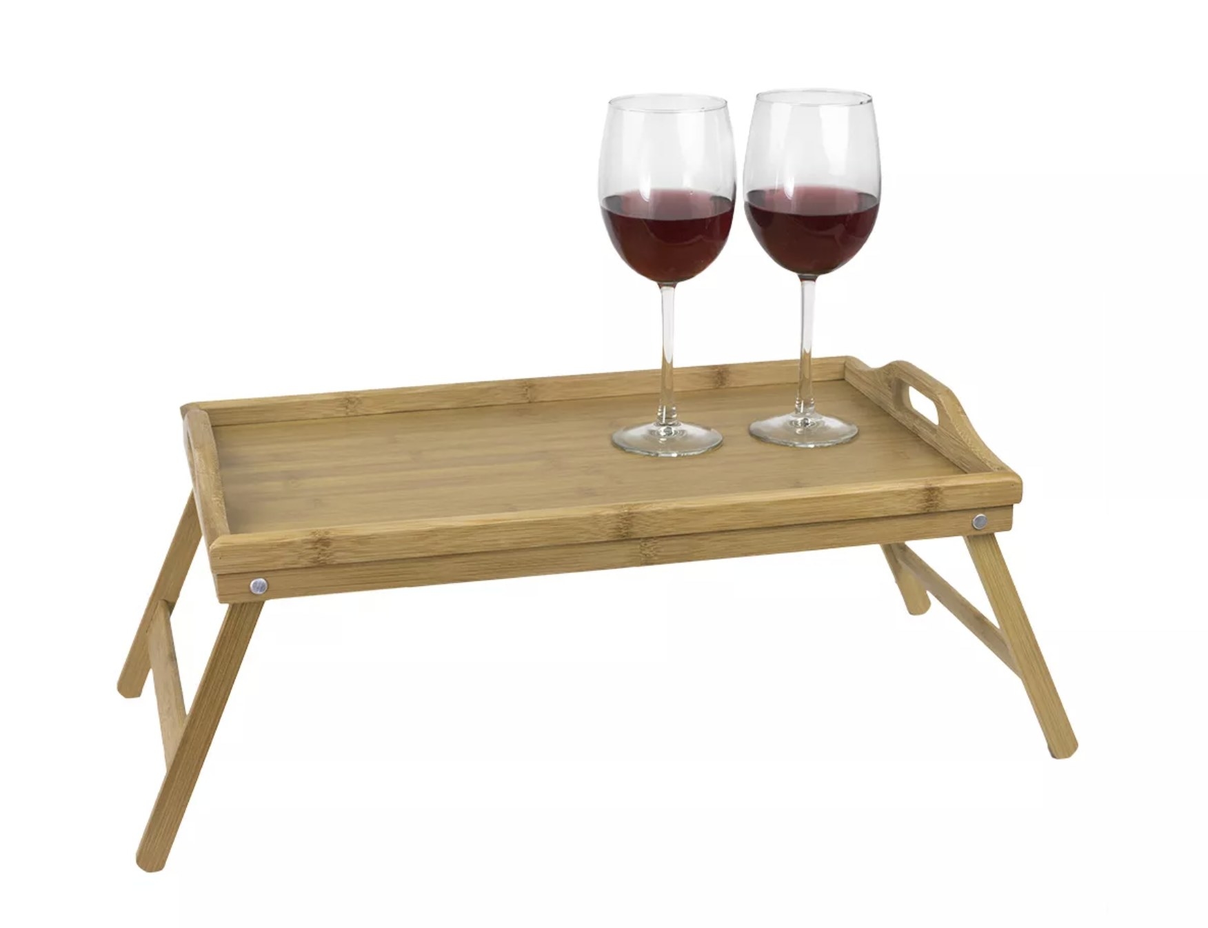 A light pine wood folding bed tray with handles and two wine glasses on top