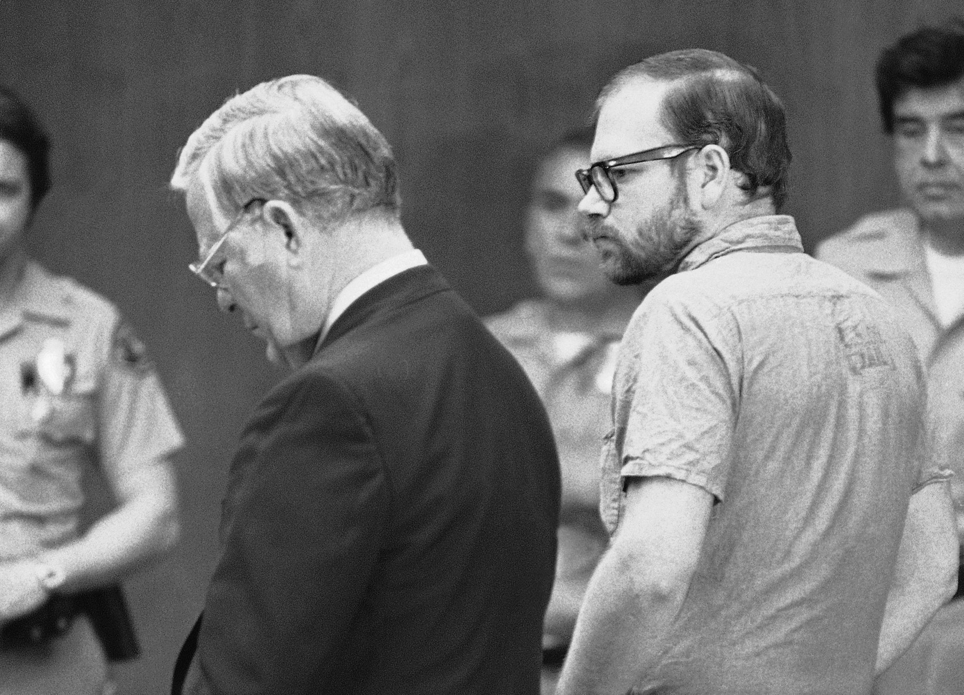 Black-and-white photo of Roy Norris entering his plea before a judge. 