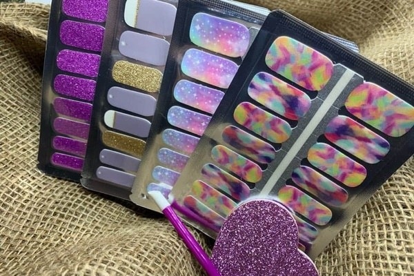multiple sets of colorful and glittery nail polish strips 
