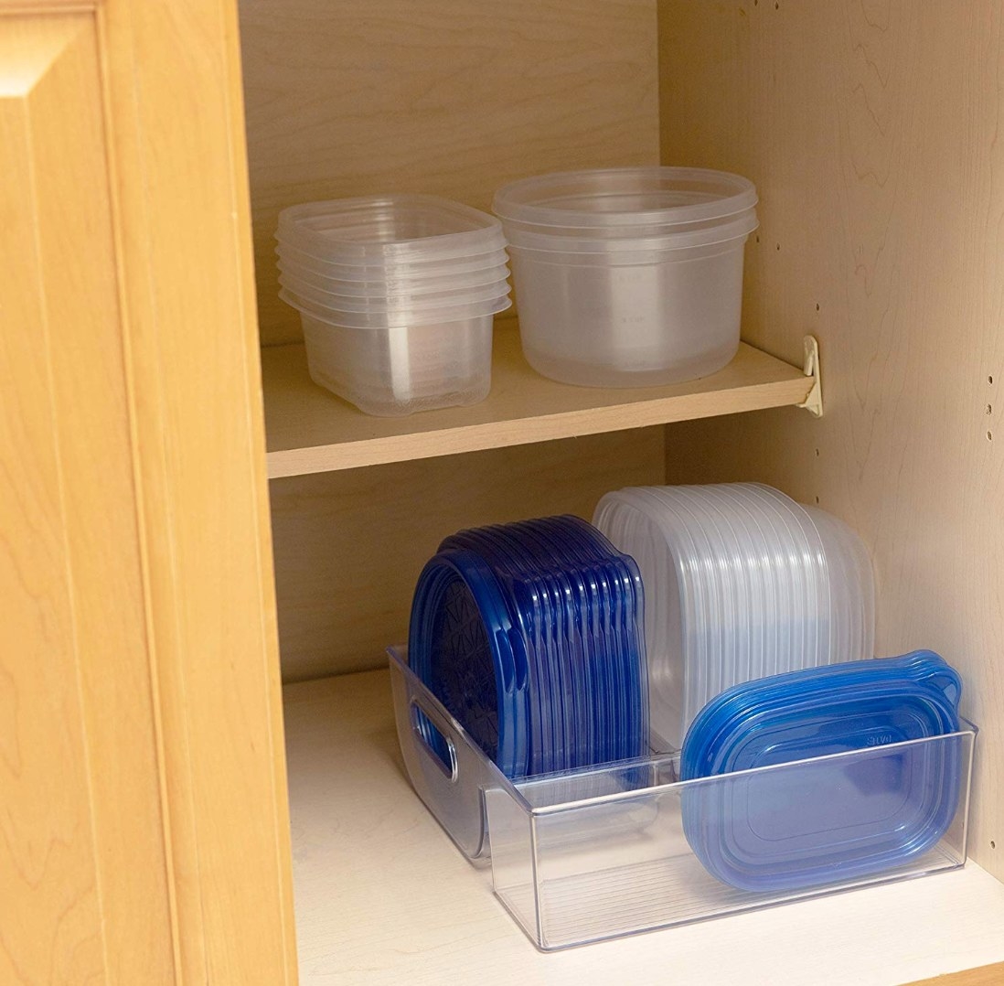 The storage container being used to hold tupperware and its lids