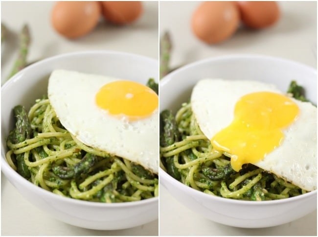A bowl of bright green spaghetti with asparagus mixed in, topped with a fried egg.