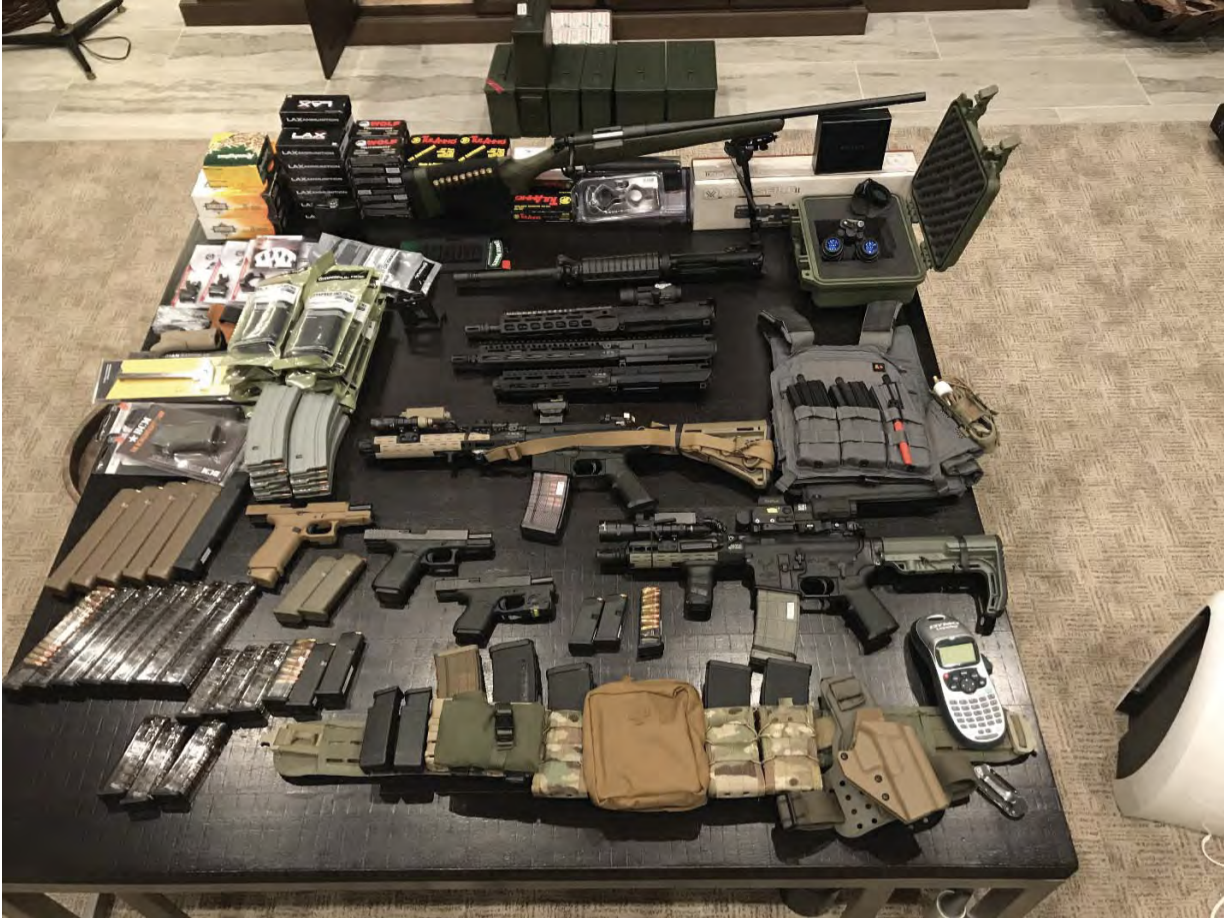 Guns and ammunition laid out across a table