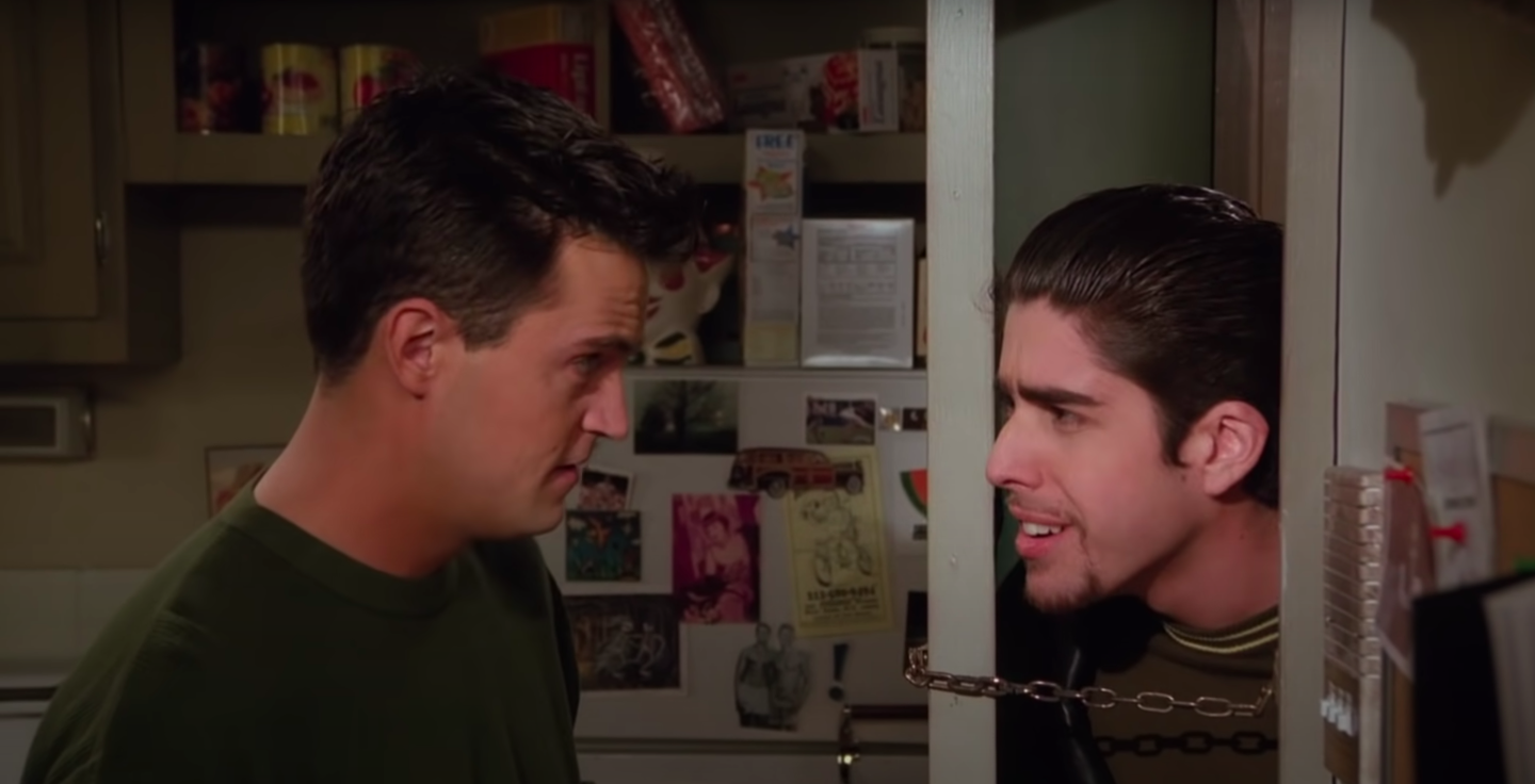 Chandler and Eddie, his roommate, argue at the door to Chandler and Joey&#x27;s apartment