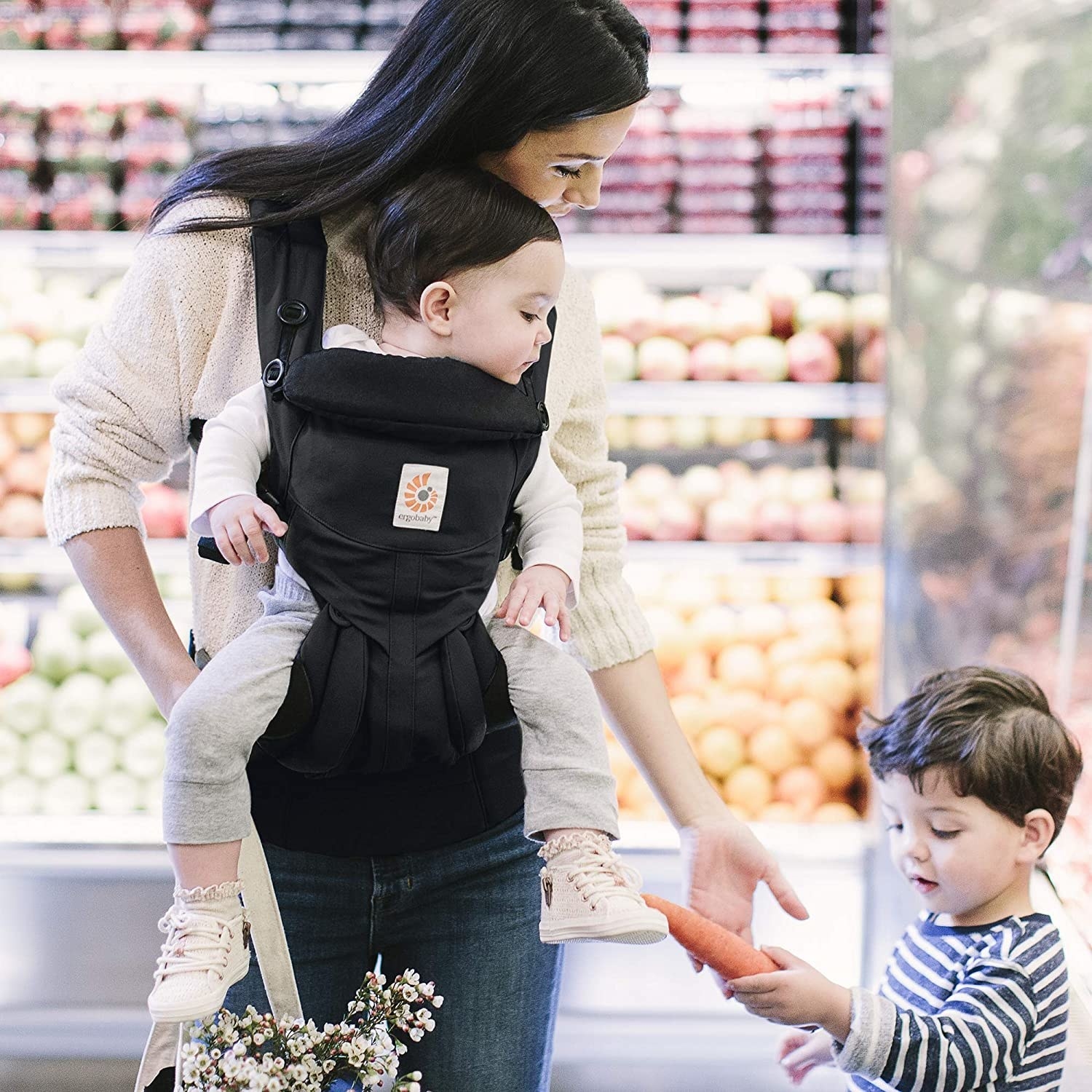 Woman holding a baby in the baby carrier