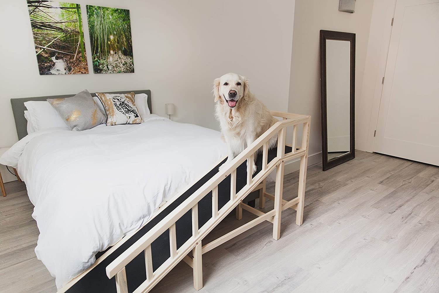 The ramp set up at the foot of a bed, with the rubber walkway slowly rising to bed height, with a railing on the far side of the ramp to prevent falls