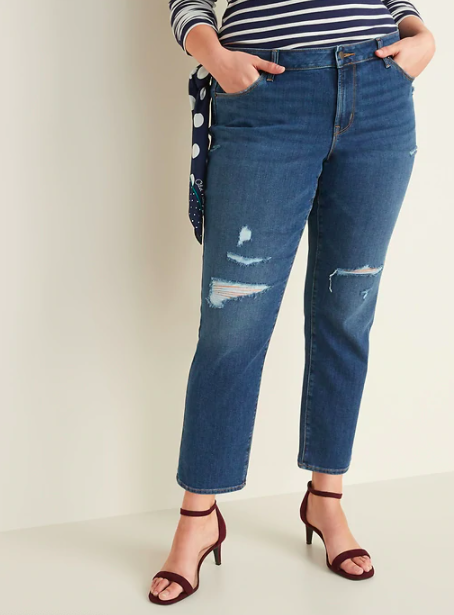A person wears a pair of distressed jeans and heels