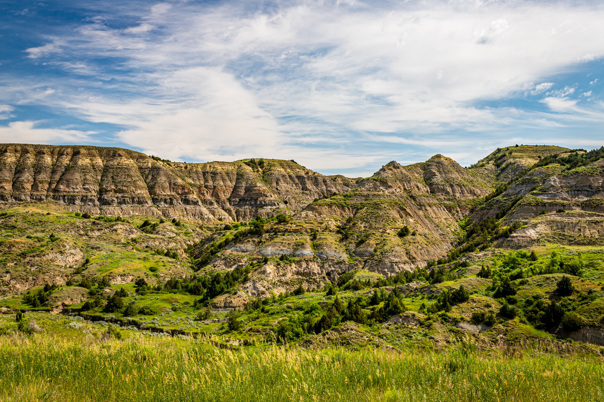 Scenic view of rocky hills covered with greenery along Theodore Roosevelt Expressway in western North Dakota