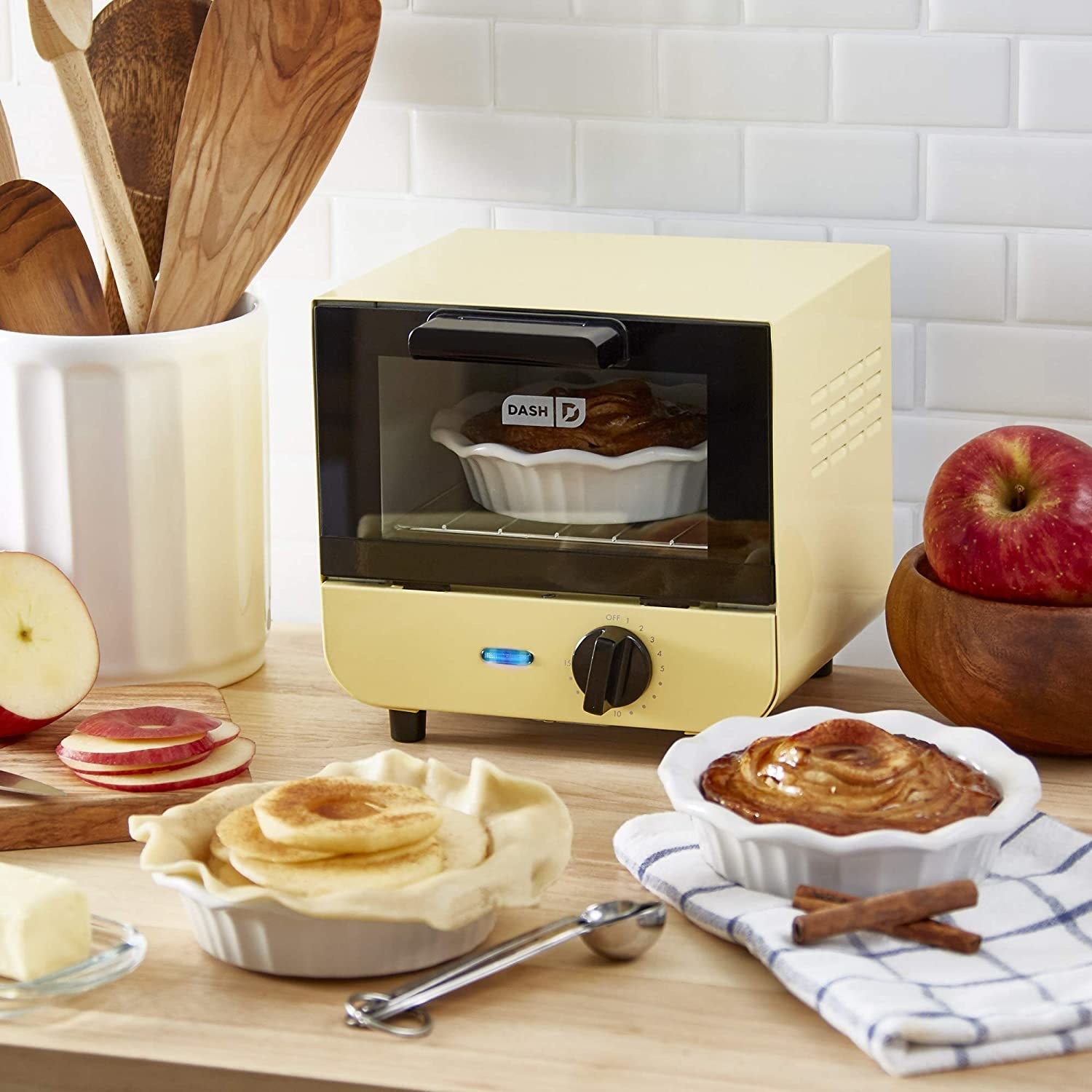A small toaster oven with a pie cooking in it