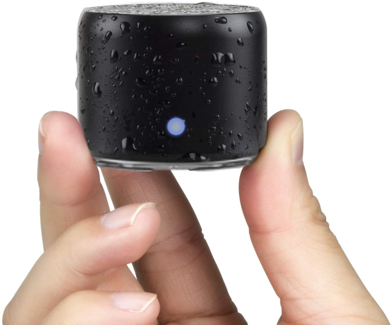 A little Bluetooth speaker being held between two fingers