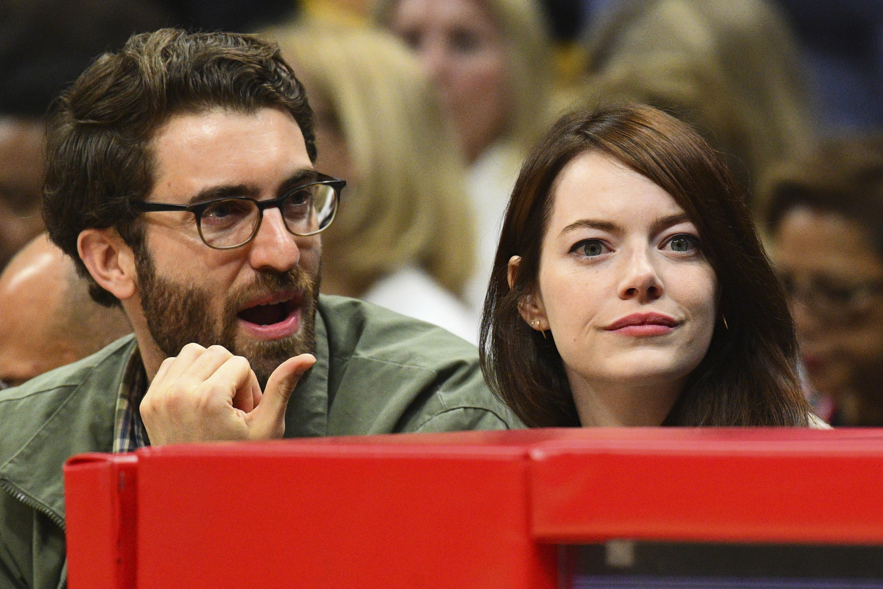 Dave explaining something to Emma at a basketball game