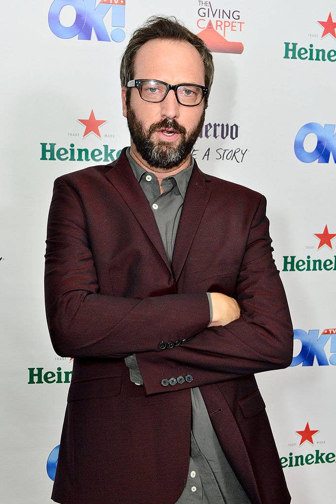 Tom wearing a suit and glasses