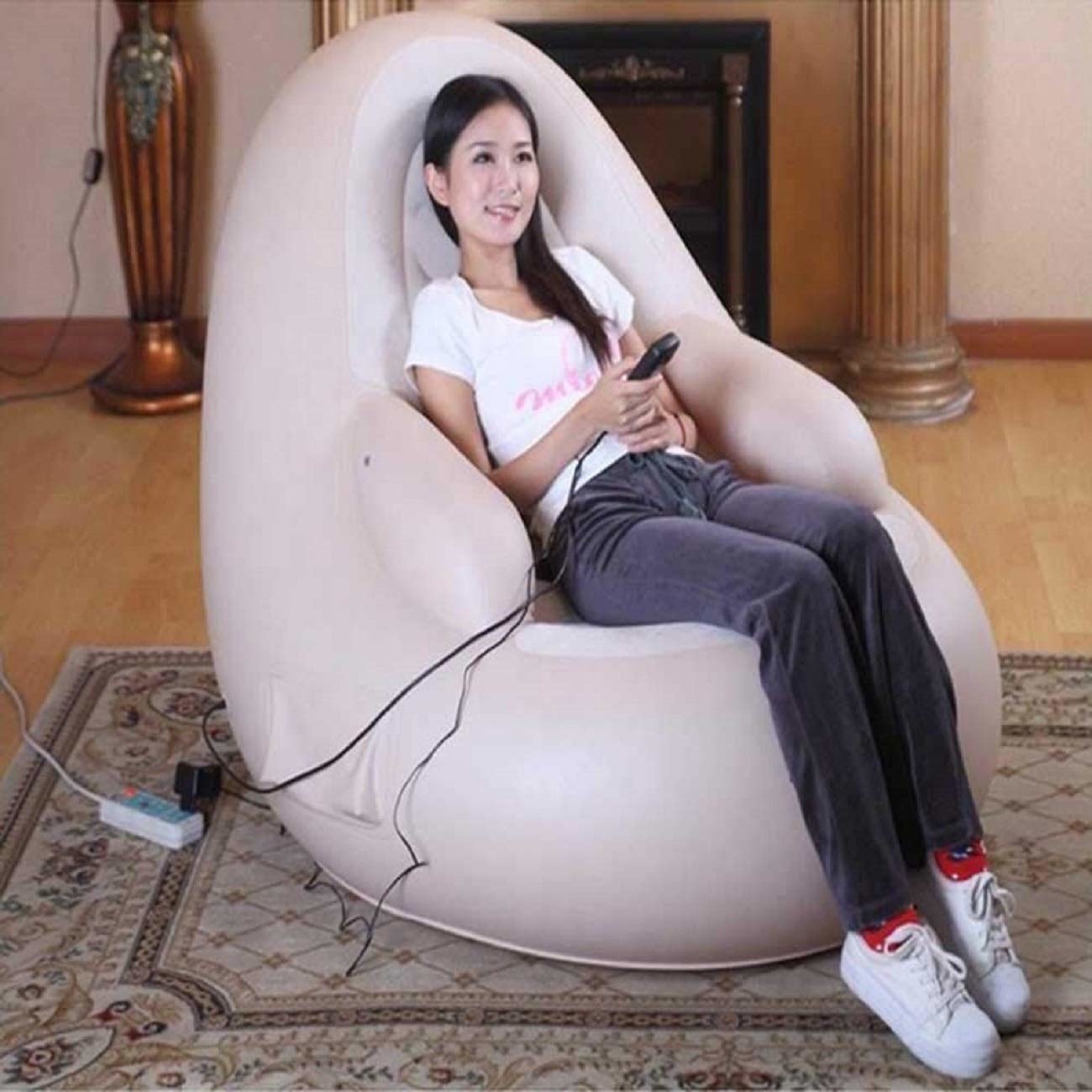 Woman sitting in the massage sofa with the remote in her hand.