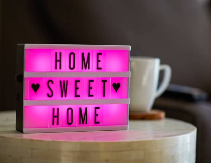 A lightbox with a pink light that says home sweet home