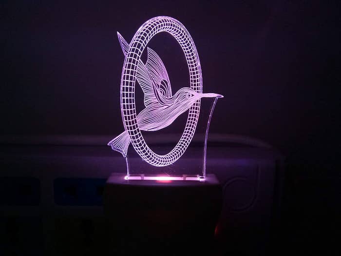 A 3D image of a bird flying in a purple light