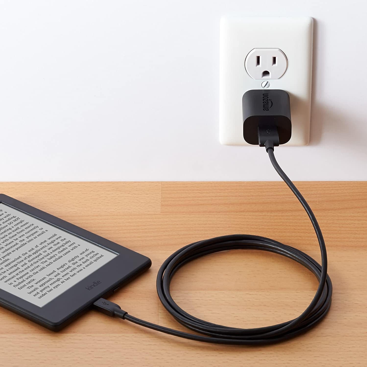 A charging cable charging a Kindle