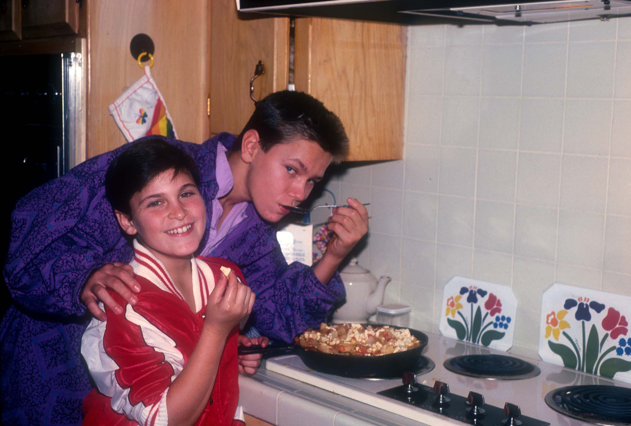 American actors Joaquin and River Phoenix cooking at their home in Los Angeles, California, US, circa 1985.