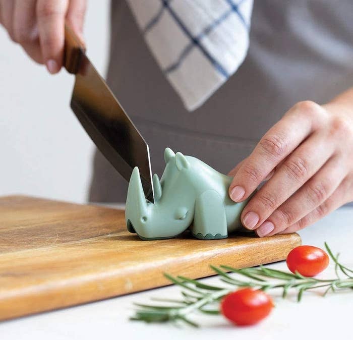 A knife is sharpened using the rhino-shaped blade sharpener