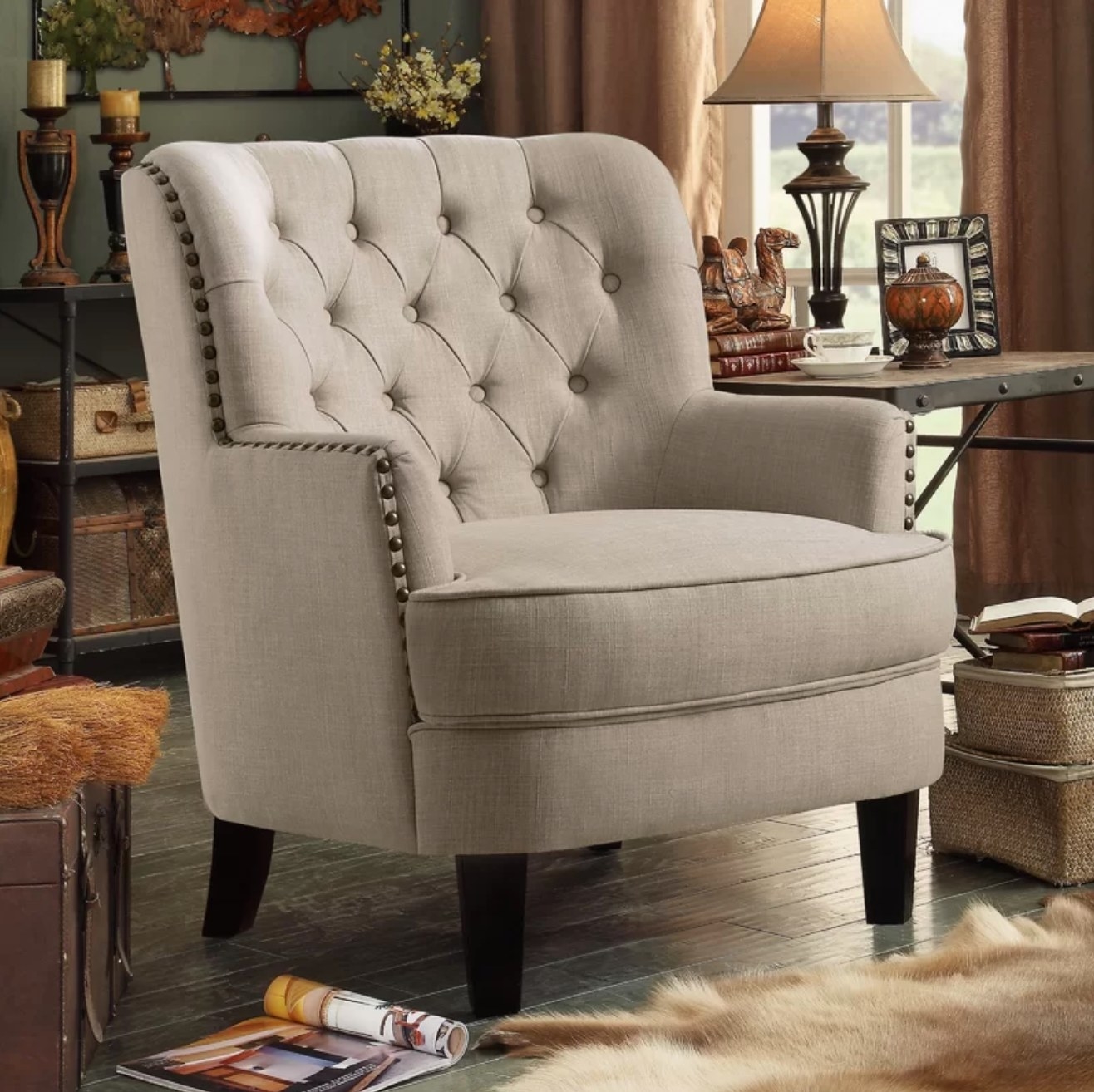 The wingback chair in beige linen situated in a living room with a fur rug