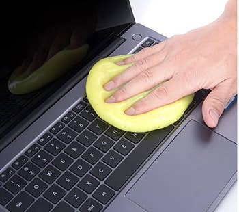 Model using yellow gel to clean a laptop keyboard