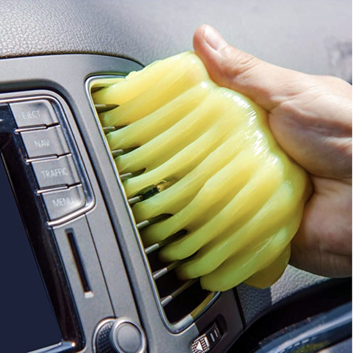 Model using yellow gel to clean an A/C unit in a car 