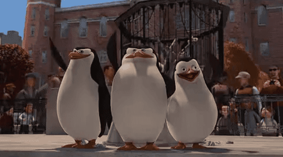 Three penguins from the movie &quot;Madagascar&quot; waving.